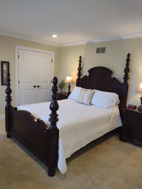 a bedroom with a large bed and two night stands at Golf Course Home - New Listing in Mason