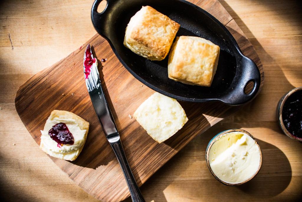 a plate of food with bread on a cutting board at Thompson Nashville, by Hyatt in Nashville
