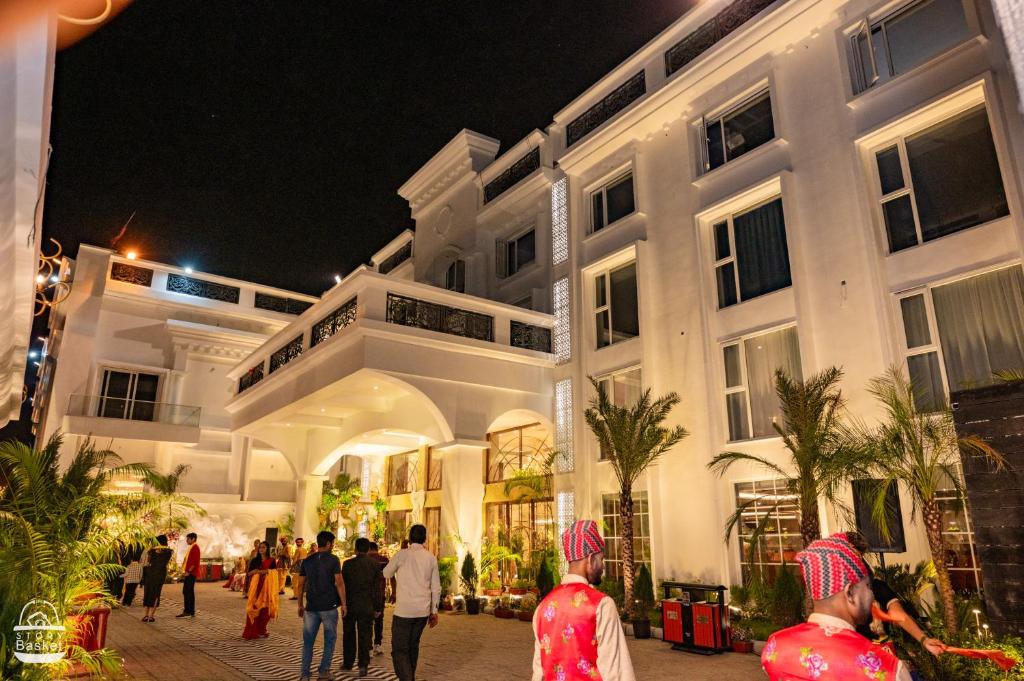 a group of people walking in front of a building at THE GRAND CASA HOTEL BANQUET SPA in Mātigara