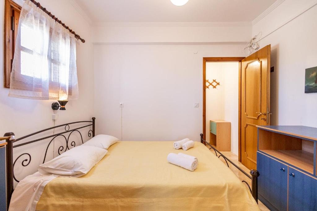 een slaapkamer met een bed met twee handdoeken erop bij House for two!! in Angairiá