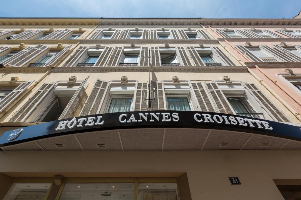 a building with a sign on the front of it at Hotel Cannes Croisette in Cannes