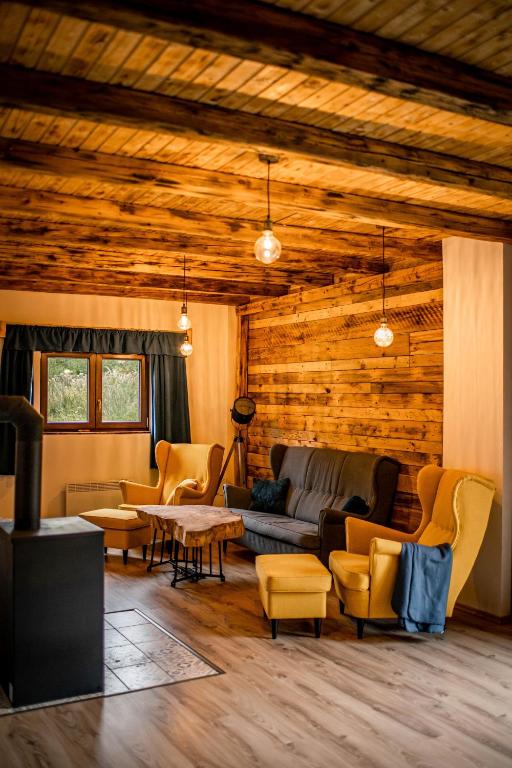 a living room with a couch and chairs and a table at Na samotě u lesa - Jeseníky in Mikulovice