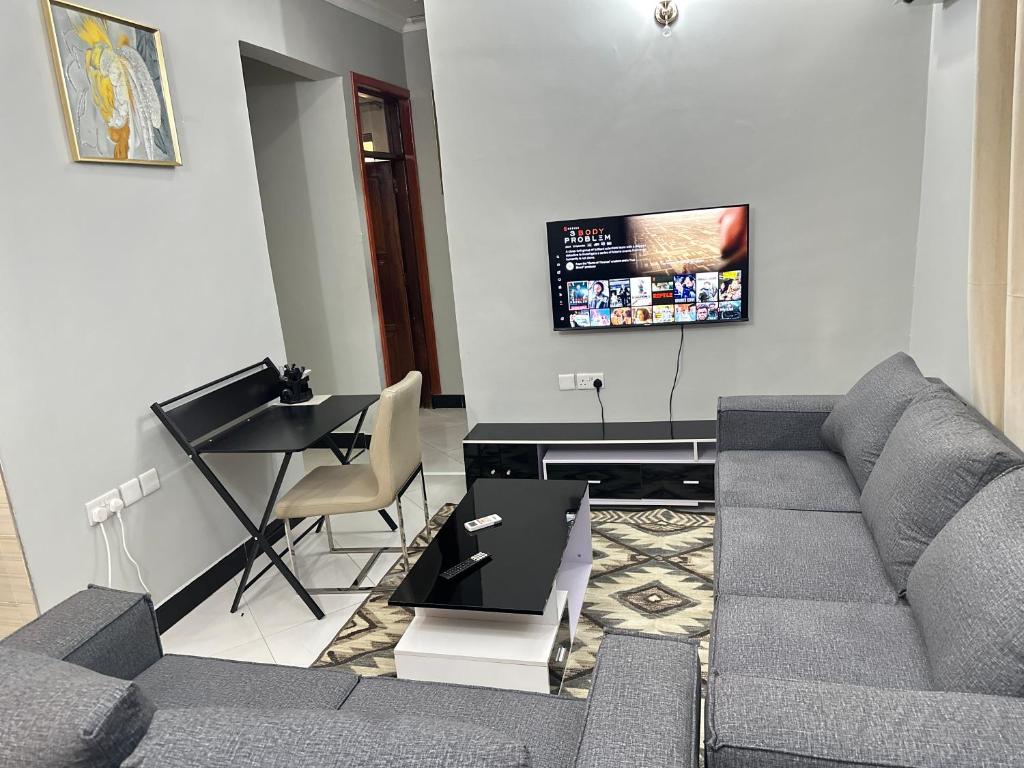 a living room with a couch and a table at Rejao Homes in Dar es Salaam