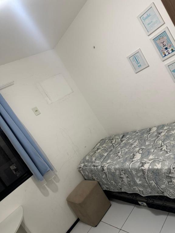 a small room with a bed in a room at Apartamento grande próximo à praia no calhau in São Luís