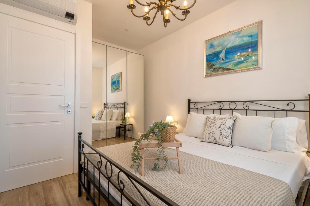 a bedroom with a bed and a chandelier at Delia's Home in Alghero