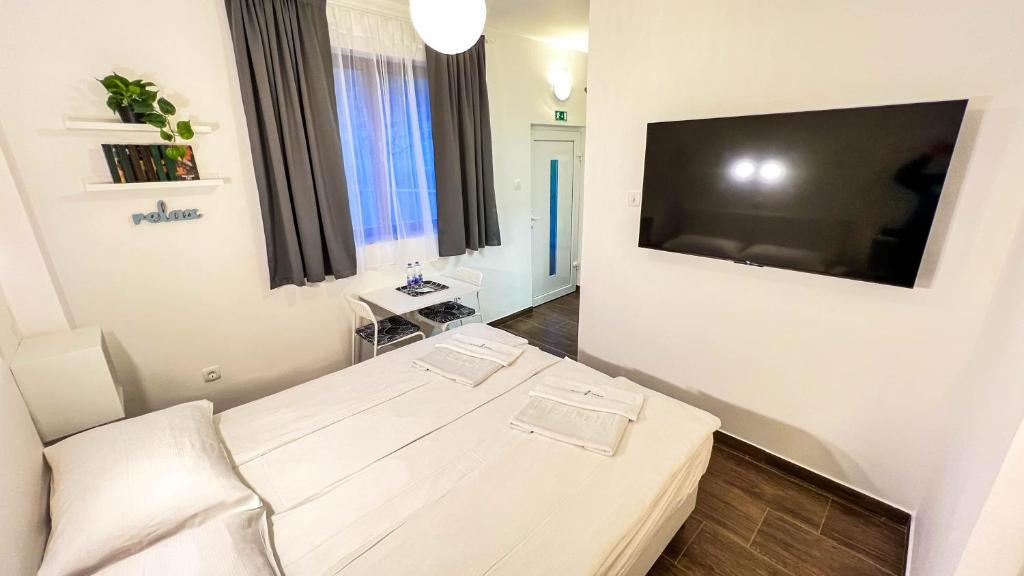 a living room with a large flat screen tv on a wall at Rooms Koblar in Portorož