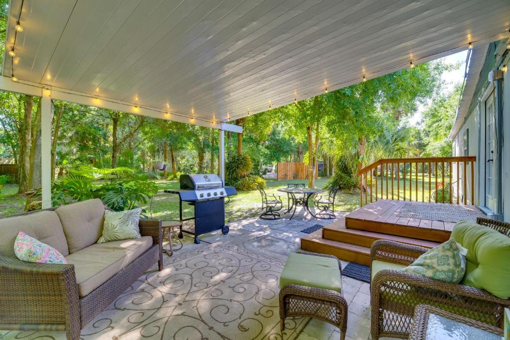 a patio with a couch and chairs and a grill at Cozy Fort Pierce Cottage on Farm Animal Rescue! in Fort Pierce