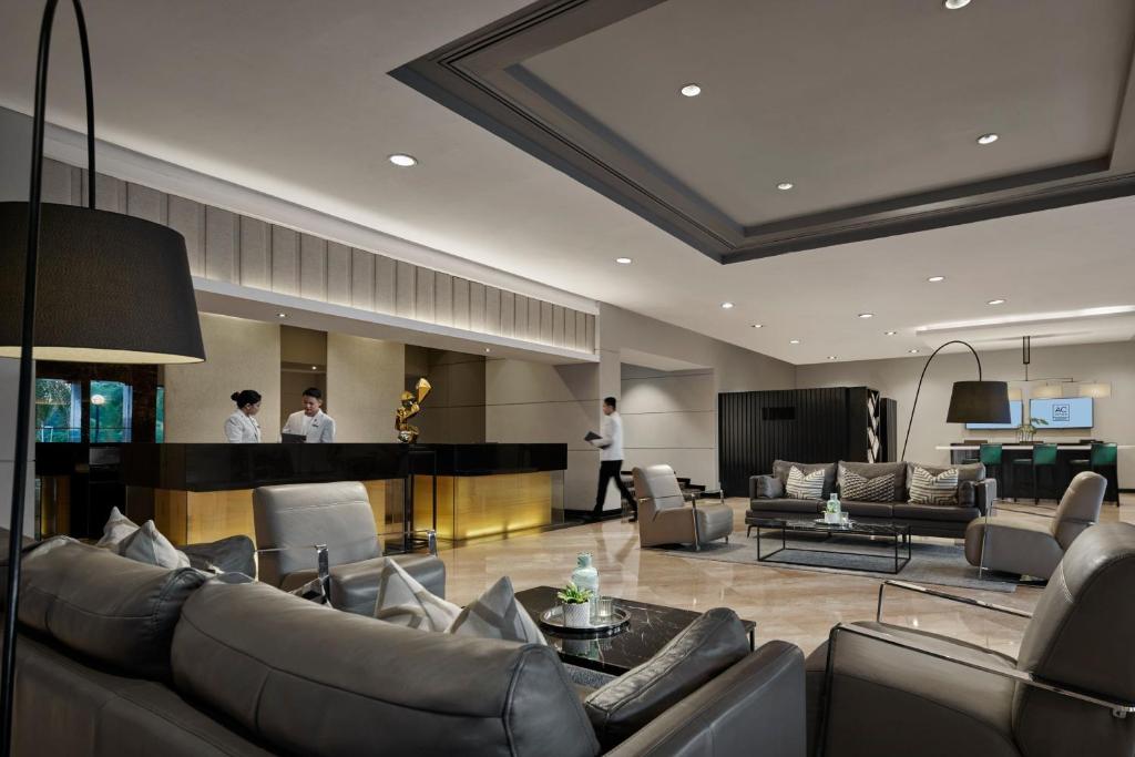 a lobby with couches and a bar in a hotel at AC Hotel by Marriott Kuantan in Kuantan