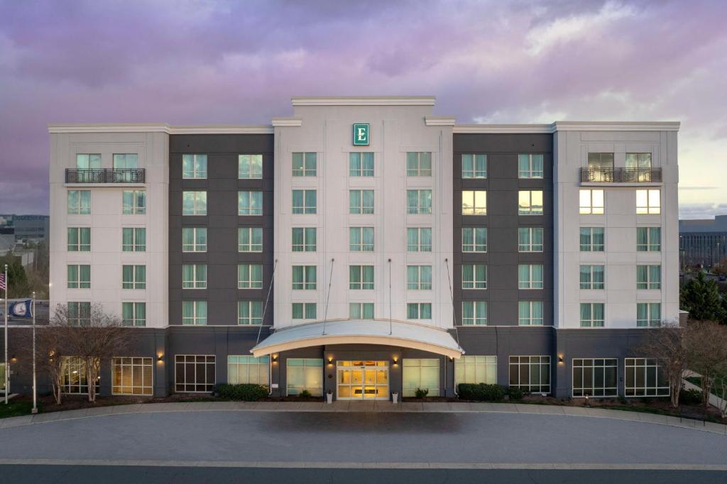 a large white building with a large entrance at Embassy Suites by Hilton Dulles North Loudoun in Ashburn