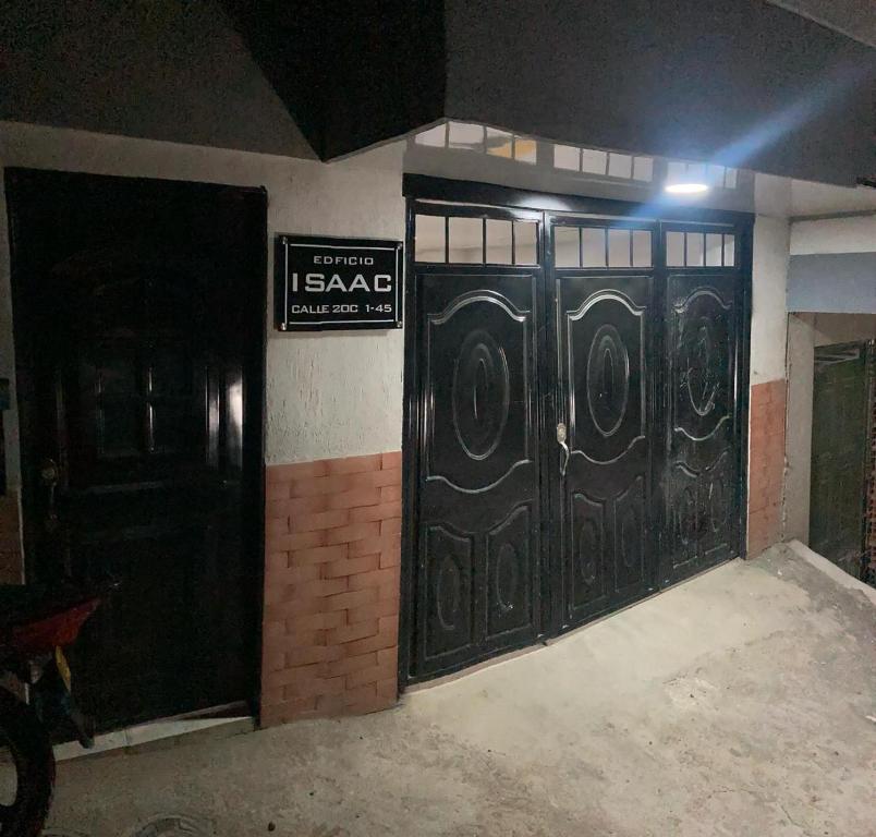 an entrance to a building with black doors and a sign at Apartahotel SANGIL in San Gil
