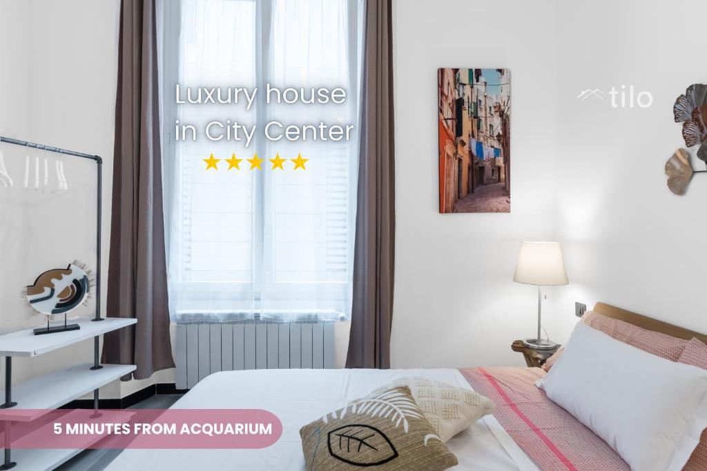 a bedroom with a bed and a window with the words luxury house in city center at ACQUARIO 5 Minuti, FREE A-C, Wifi & Netflix ''City Center'' by TILO in Genoa