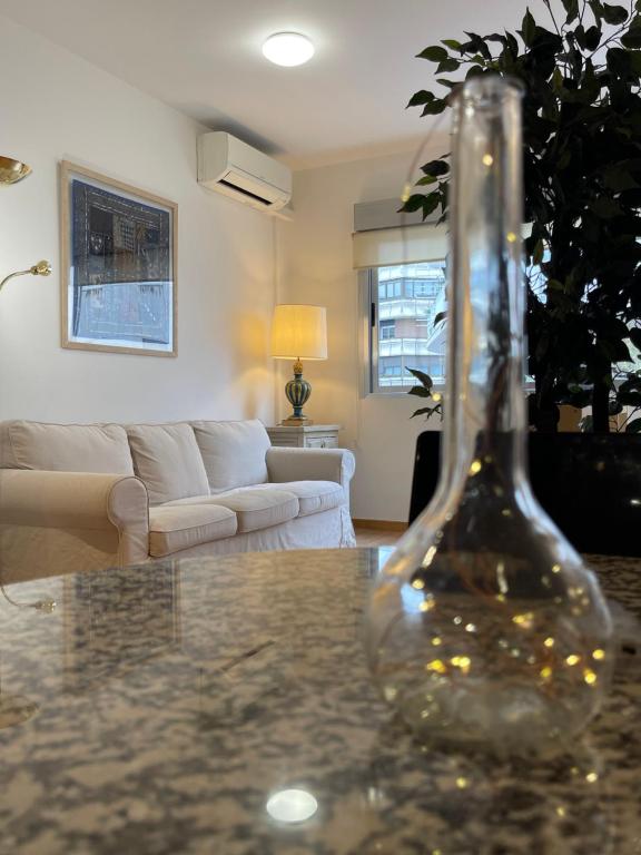 a glass vase sitting on a table in a living room at Bernabéu Loft Moderno in Madrid