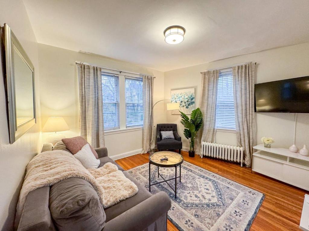 a living room with a couch and a table at Longwood Medical Condominium in Brookline