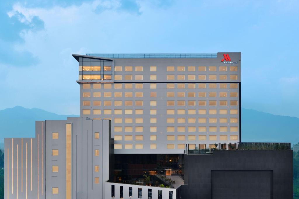 a tall building with a balcony on top of it at Kathmandu Marriott Hotel in Kathmandu