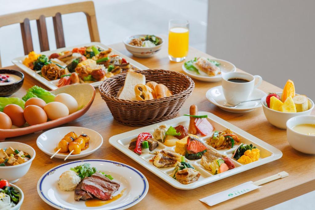 une table en bois avec des assiettes de nourriture dessus dans l'établissement Tendo Hotel, à Tendō