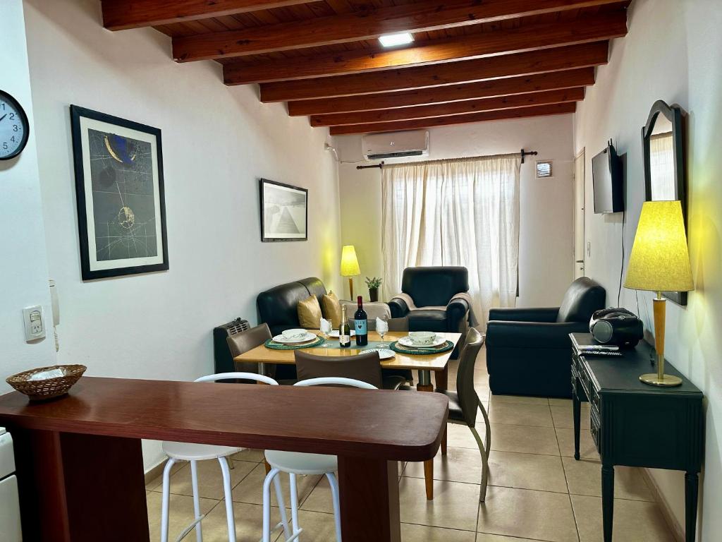 a living room with a table and chairs and a living room at Sol y Vida in Godoy Cruz