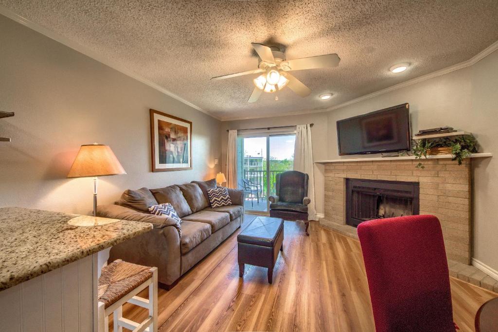 a living room with a couch and a fireplace at Sweet Retreat RRC A203 in New Braunfels