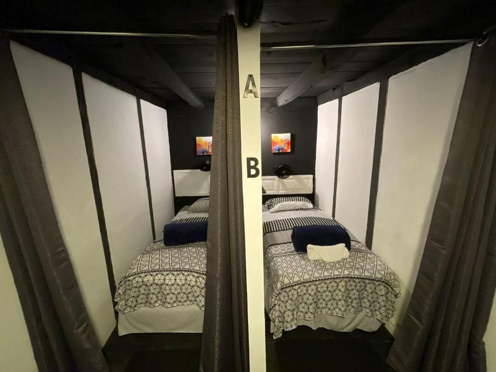 two bunk beds in a room with a mirror at The Hostal Pub Antigua Guatemala in Antigua Guatemala