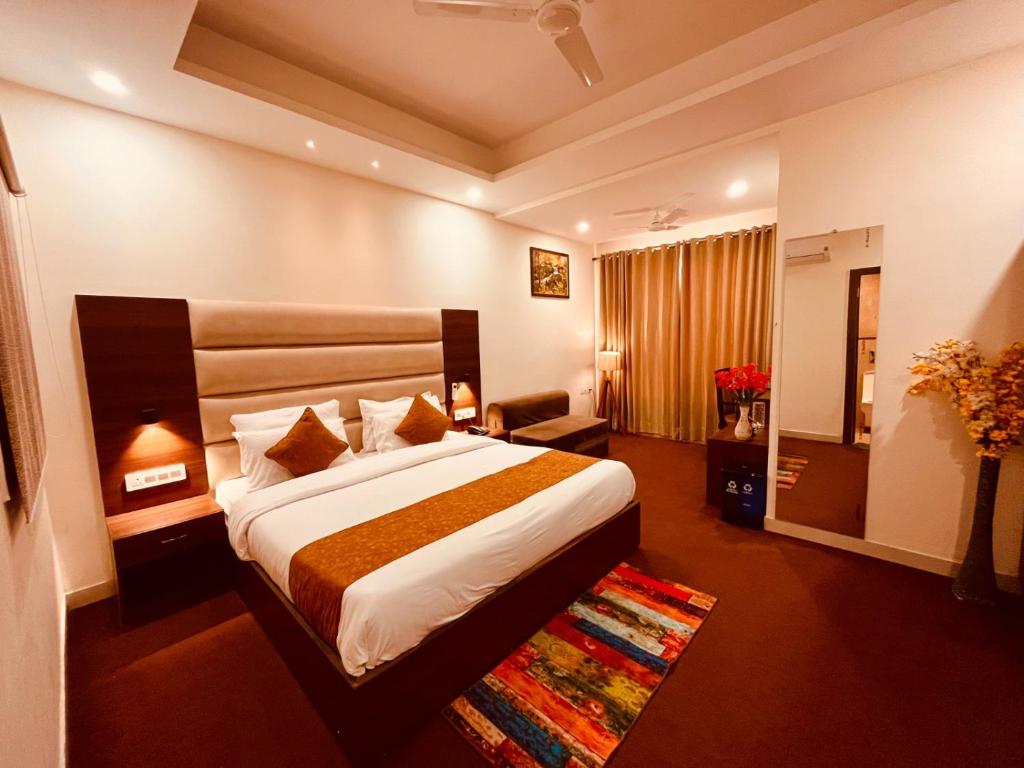 a hotel room with a large bed in a room at Raga Resort, Haridwar in Haridwār