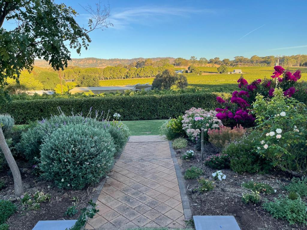 a garden with colorful flowers and a walkway at Barossa Garden Homestay in Williamstown