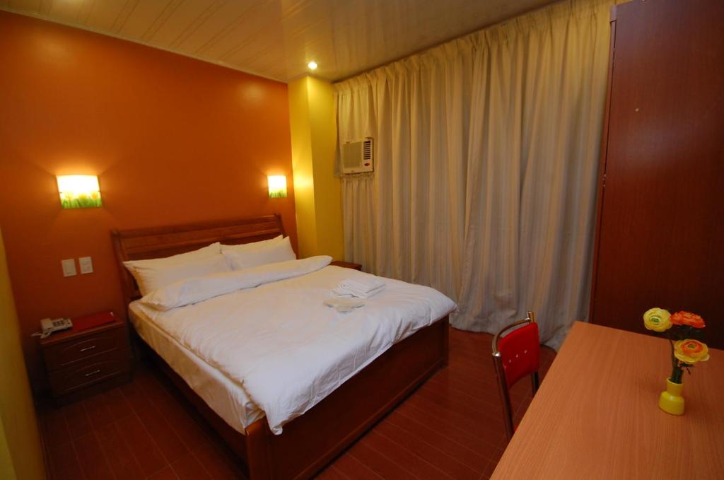 Postel nebo postele na pokoji v ubytování A&A Plaza Hotel