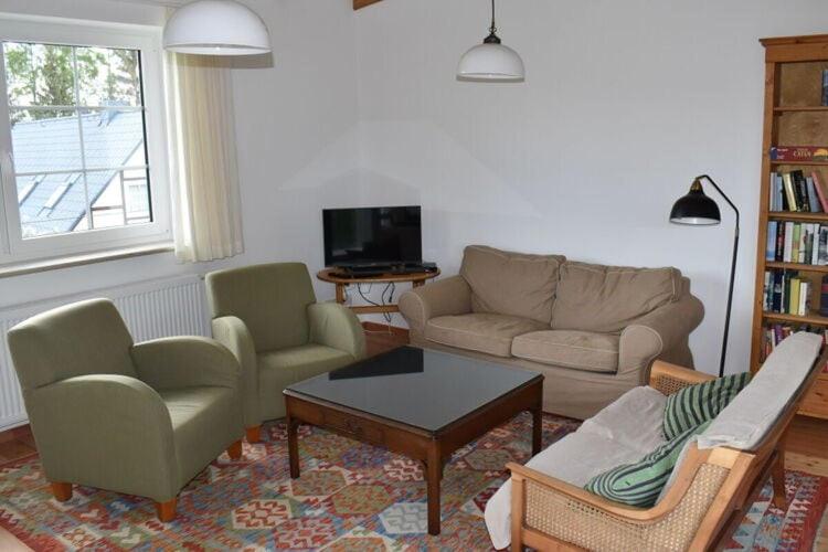 uma sala de estar com um sofá, cadeiras e uma mesa em Holiday apartment in Flieth-Stegelitz 