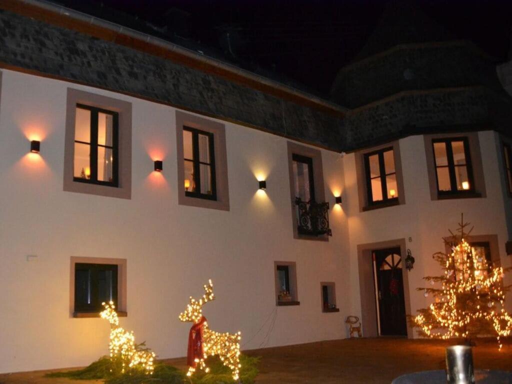 a house with christmas lights and a christmas tree at Halfenschänke Modern retreat in Piesport