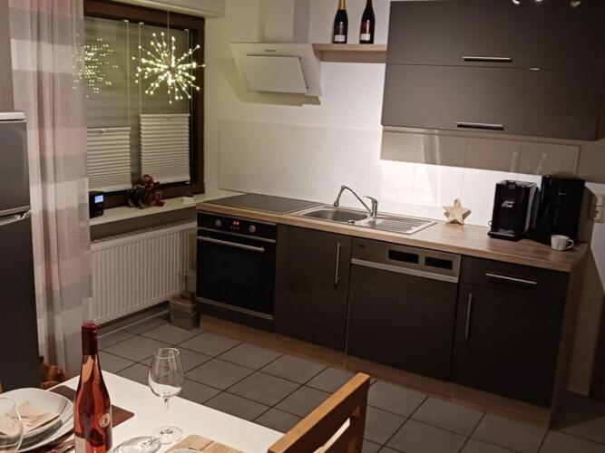 a kitchen with a sink and a stove top oven at Holiday apartment Goldkäulchen in Waldrach