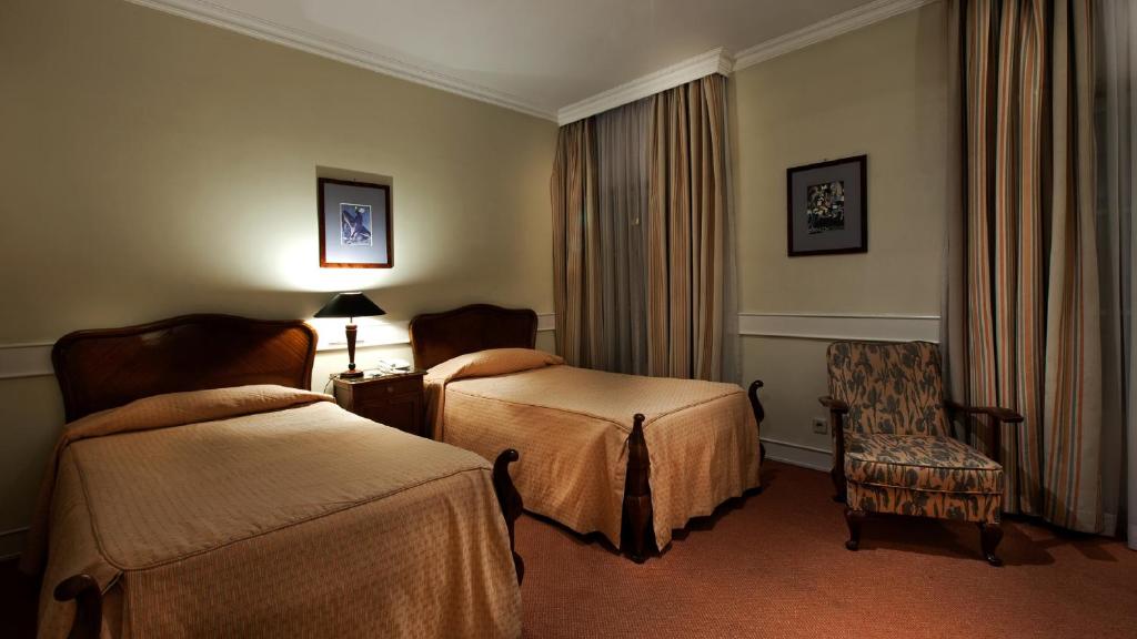 Postel nebo postele na pokoji v ubytování Hotel Metropole