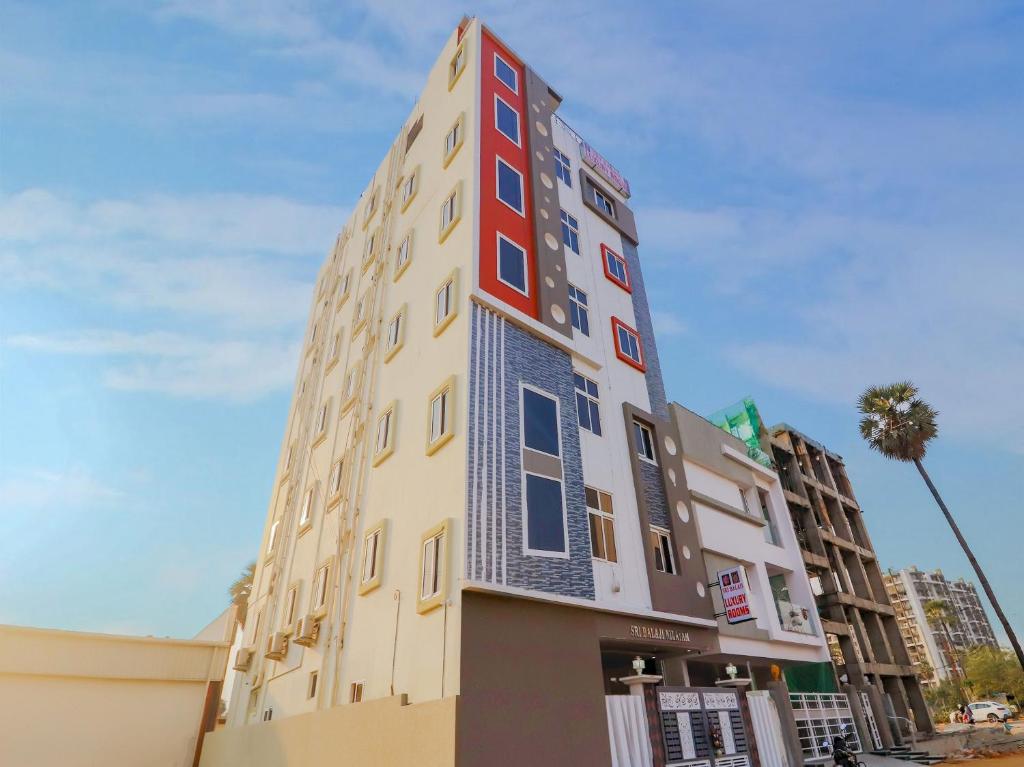 a tall building with red and blue windows at Home Sri Balaji Luxary Rooms Near Inorbit Mall Cyberabad in Gachibowli
