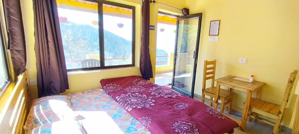 a small bedroom with a bed and a window at Ababeel Homestay, Hartola in Rāmgarh