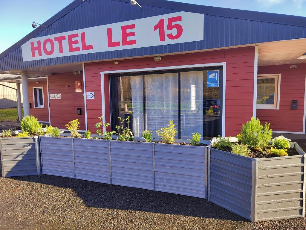a hotel le building with plants in front of it at Hôtel Le 15 Périgueux in Coulounieix-Chamiers