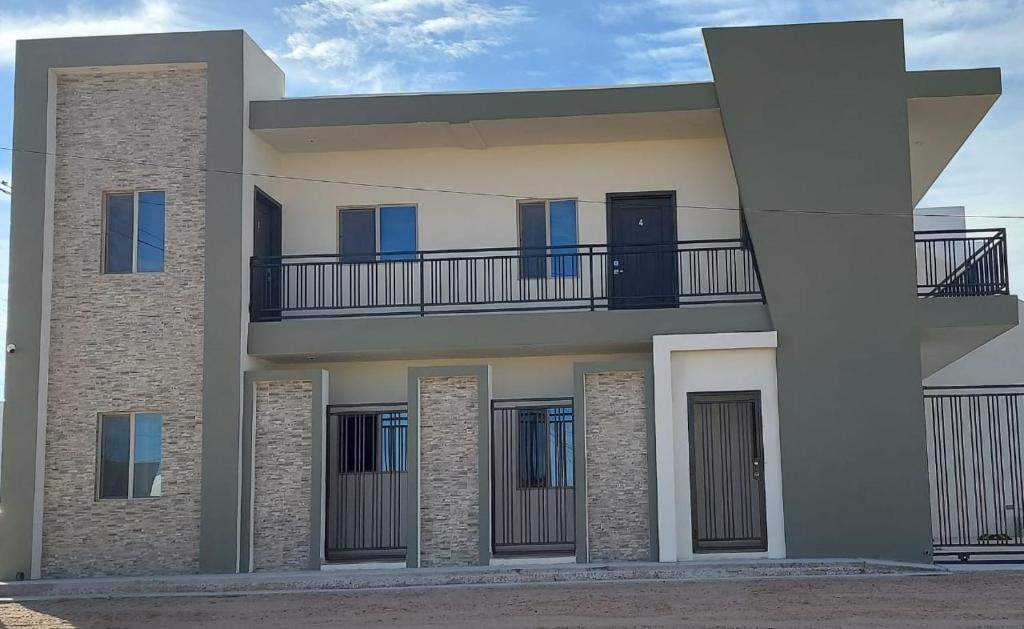 a house with a balcony on the side of it at Departamentos Ada's in Puerto Peñasco