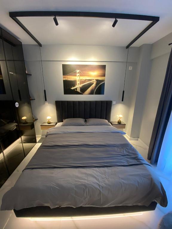 a bedroom with a large bed with lights on it at AIR Studio & Garden in Otopeni