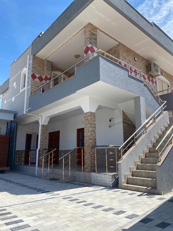 a building with stairs on the side of it at Davide's guesthouse in Vlorë