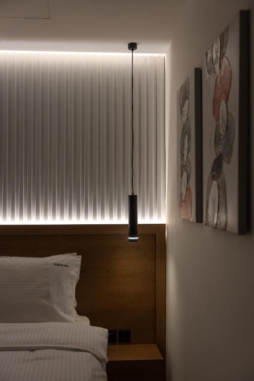 Postel nebo postele na pokoji v ubytování Volos Inn Hotel