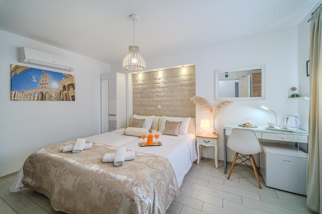 a hotel room with two beds and a desk at Central Split rooms and apartments Paese in Split