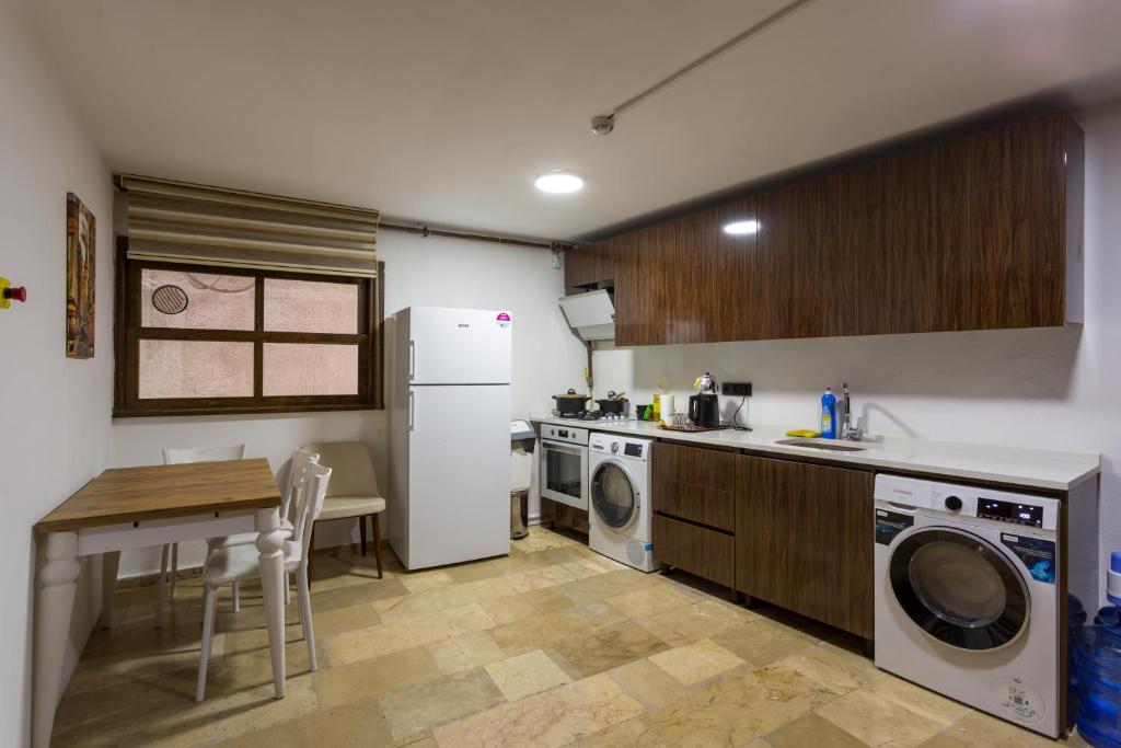 a kitchen with a washer and dryer and a table at Dream Park Hotel in Istanbul
