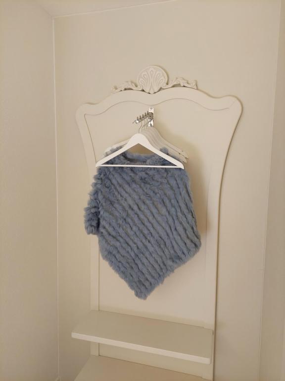 a blue towel is hanging on a towel rack at Dolceresio Lugano Lake B&B in Brusino Arsizio