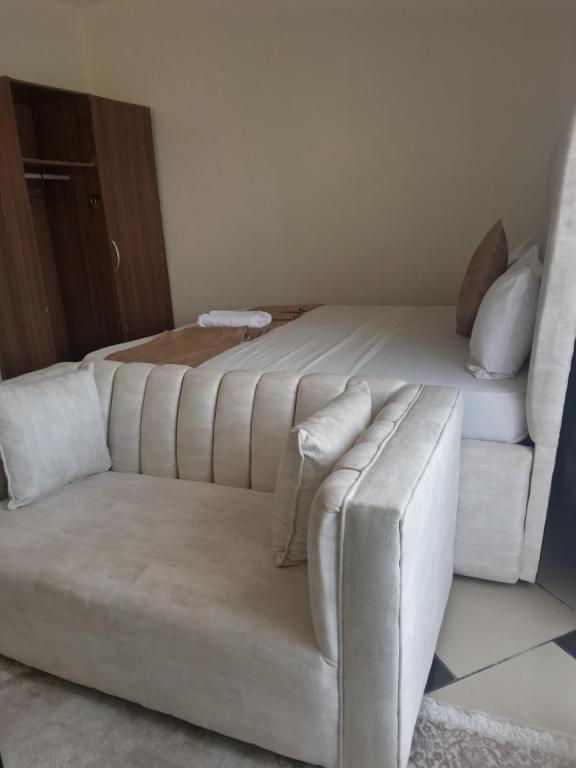 a living room with a couch and a bed at Tamara Studio Apartment in Shanzu in Mtwapa