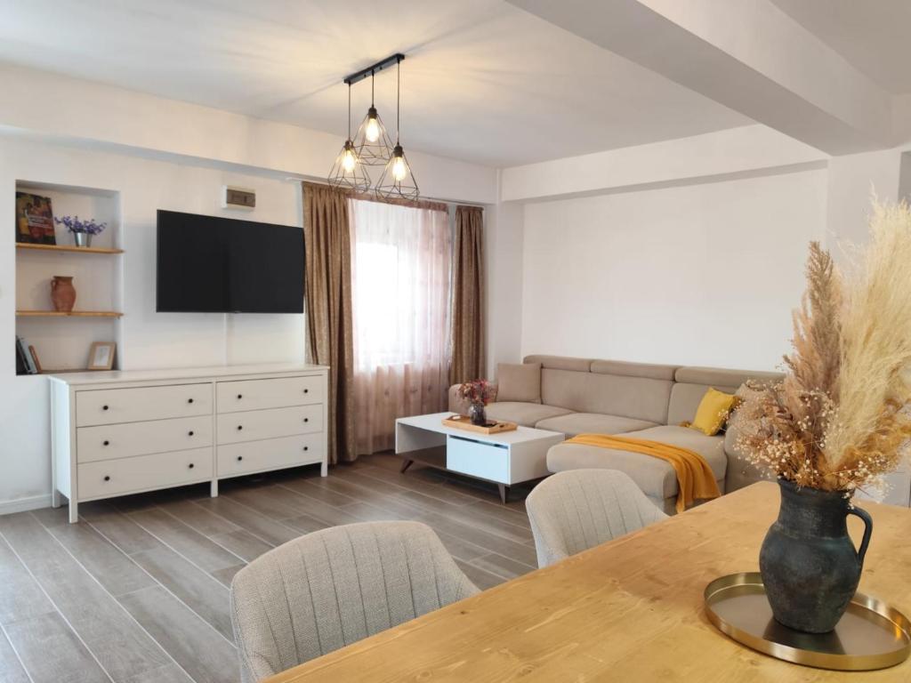 a living room with a couch and a table at Vila Didi, Mangalia in Mangalia