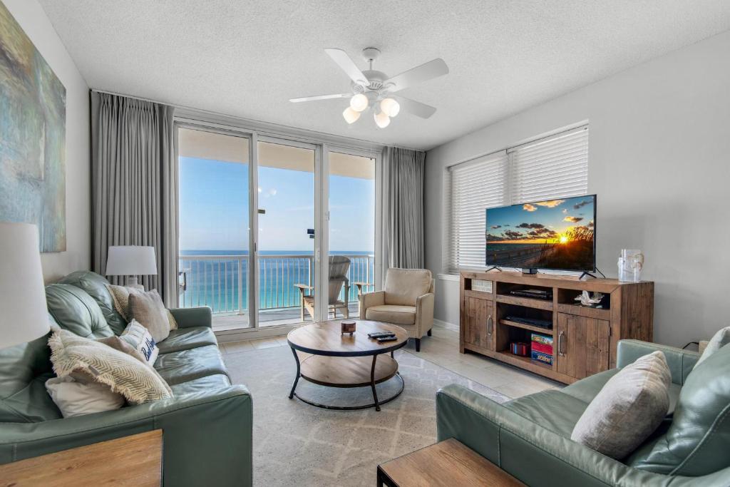 a living room with a couch and a tv at Summerwind Center 1304 in Navarre