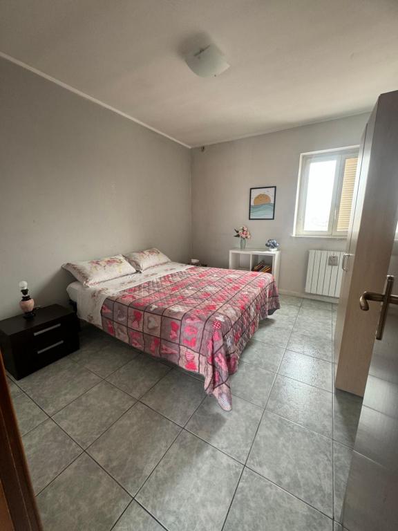a bedroom with a bed and a window at Neartheairport in Fiumicino