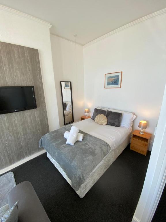 a bedroom with a bed and a flat screen tv at Farina No1, Sea view studio sleeping 2 guests in Bridlington