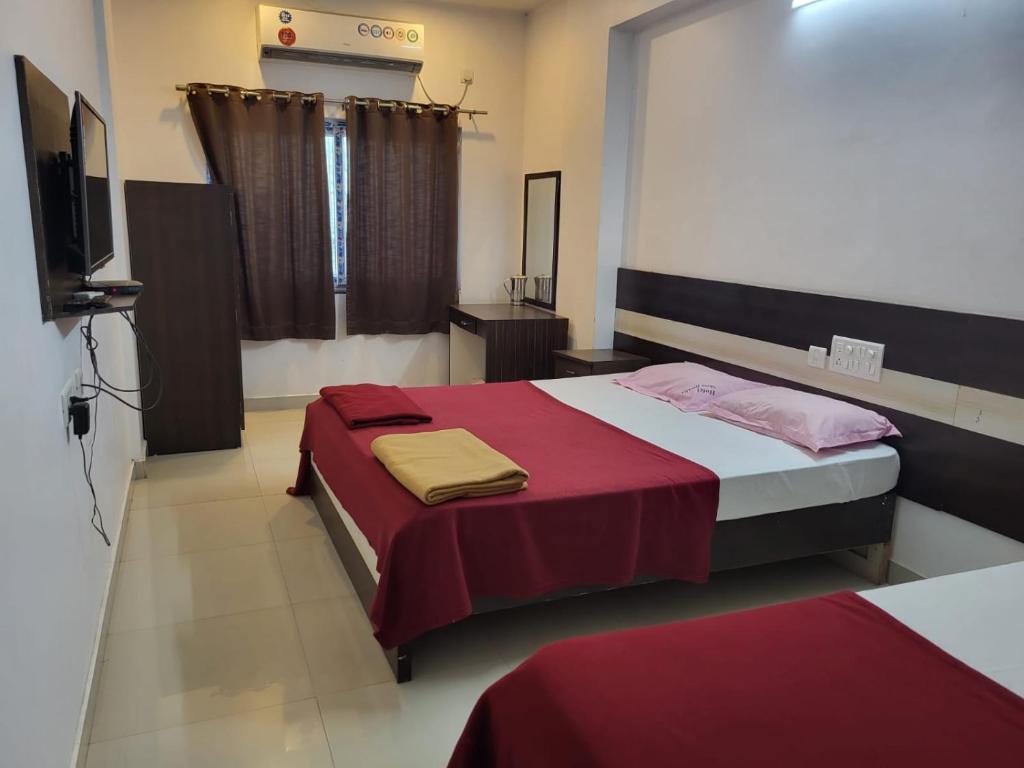 Postelja oz. postelje v sobi nastanitve Suja Krishna residency