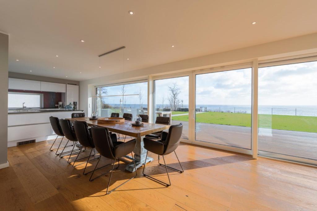 a kitchen and dining room with a table and chairs at Villa "Haus am Meer" in Dahme