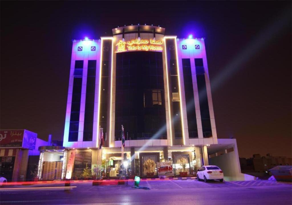 a large building with blue lights on top of it at هذا منزلي الحمرا in Riyadh