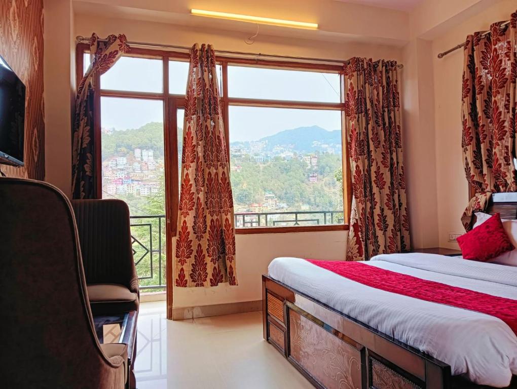 a bedroom with a bed and a large window at The White House - A Four Star Luxury Hotel in Shimla