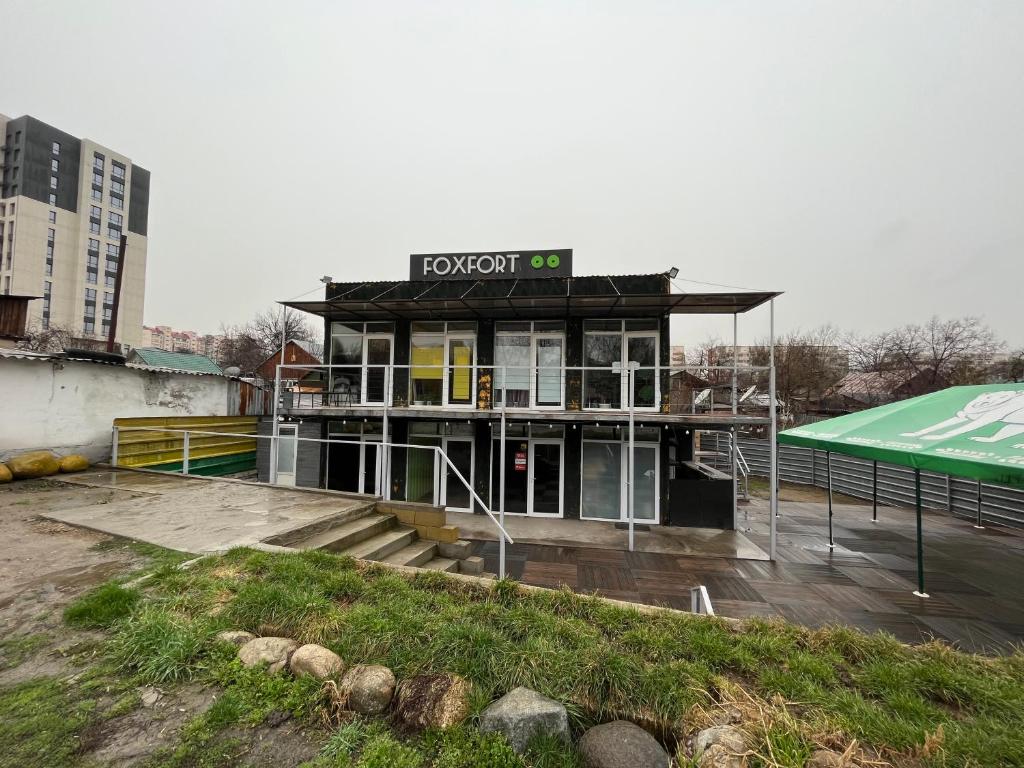 a building with a sign on top of it at Fox Fort Hostel in Almaty