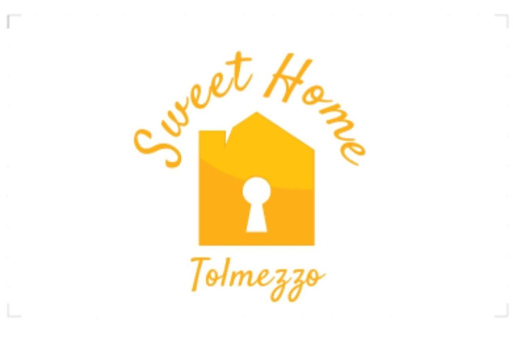 a logo for a guest house with a keyhole at Sweet Home in Tolmezzo